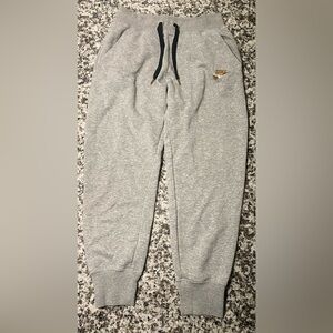Nike Women's Gray Track Pants with Rose Gold Emblem & Lettering